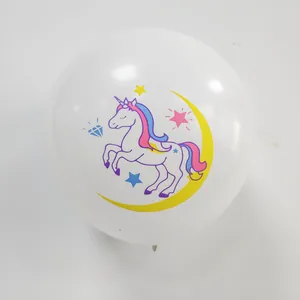 Close-up of a white latex balloon with colorful unicorn, moon, and stars party pattern