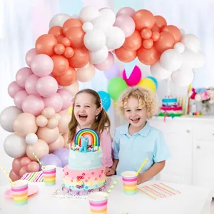 Détail de l'arche de ballons avec macarons roses, oranges et blancs pour mariage