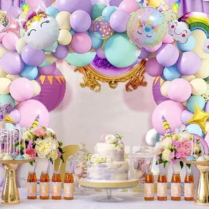 Unicorn birthday party arch with macaron rainbow latex balloons and foil star accents