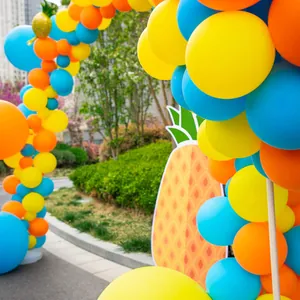 Detail of Hawaii fruit theme balloon arch with yellow, blue, orange balloons and pineapple board