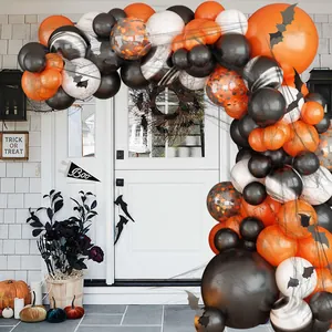 Halloween balloon arch kit with orange, black, and white balloons for outdoor porch decor