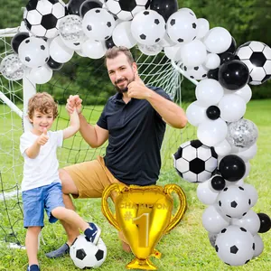Outdoor setup of soccer balloon arch kit with gold champion trophy and white latex balloons