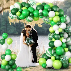 Detail of sage green balloon arch with marble and confetti balloons for outdoor weddings