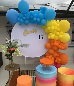 Hawaiian fruit themed party balloon arch kit with round backdrop and cylinder pedestals