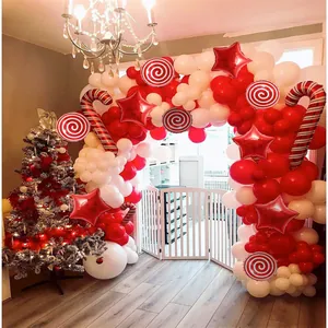 Detailed Christmas balloon arch with candy cane and star foil balloons for festive party decor