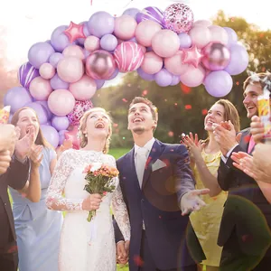 Detail of pink and purple balloon arch kit with metallic stars for party decoration