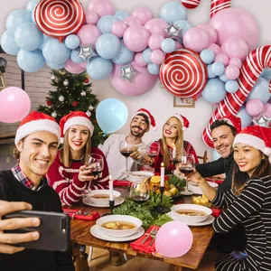 Christmas balloon arch kit with pink and blue latex balloons and candy cane foil decorations