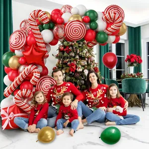 Family setting with Christmas balloon arch featuring candy canes and star foil balloons