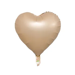 Matte champagne gold heart-shaped foil balloon with visible inflation valve on white background