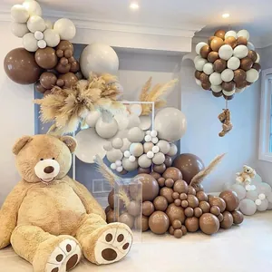 Detail of coffee brown and cream balloon arch with pampas grass and teddy bears