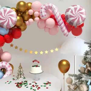 Pink Christmas balloon arch kit with candy canes, stars, and lollipops for party decor