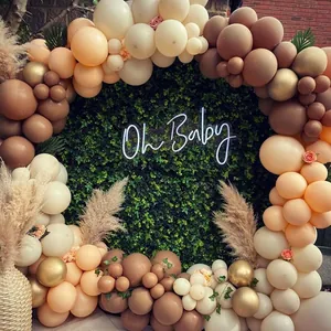 Detail of coffee and cream balloon arch kit with Oh Baby neon sign for party decor