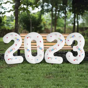 Close-up of 40-inch white 2023 foil number balloons with colorful Happy Birthday prints