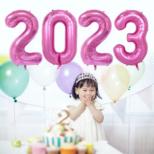 Close-up of pink 2023 foil number balloons for New Year and party backdrop decoration