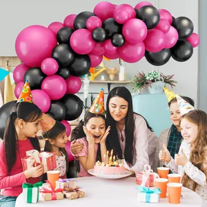 Hot pink and black balloon arch kit for birthday party decorations with party hats