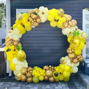 Detail of pineapple balloons and sunflower accents in a yellow gold party arch set