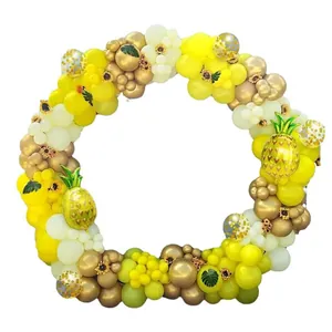 Hawaiian pineapple balloon garland kit with yellow gold balloons and tropical leaves