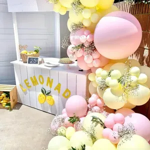 Macaron daisy balloon garland kit with pink yellow and white tones for birthday party