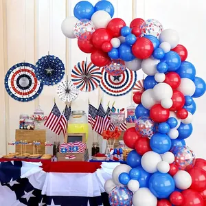 Detail of red white and blue balloon arch with paper fans for Independence Day party decor