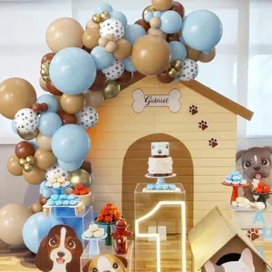 Blue and brown dog party balloon arch kit with paw prints and bone decorations