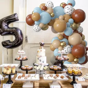 Blue and brown balloon arch with paw prints and giant number five for pet birthday party