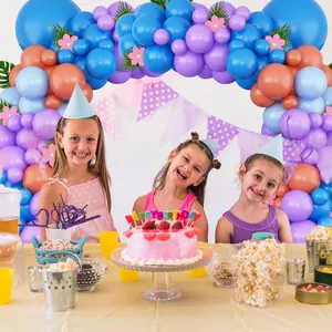Blue and purple balloon arch kit with floral accents and festive party flags