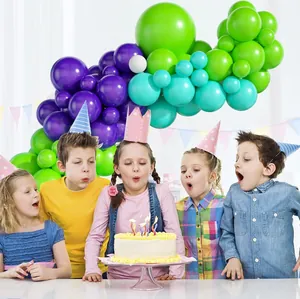Close-up of vibrant blue and purple balloon arch set for a colorful birthday party scene