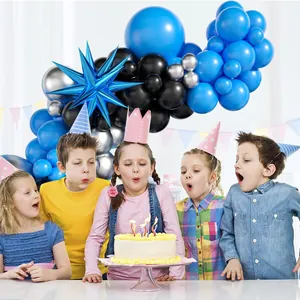 Kids celebrating party with blue black balloon arch kit and exploding star balloon backdrop
