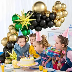 Gold and green balloon arch kit with star balloons for birthday party celebration scene