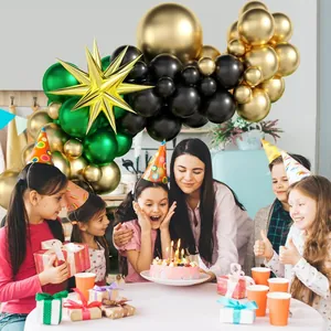Detail of green and gold balloon arch kit with large starburst foil balloon for party decor