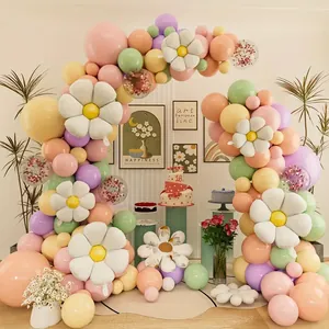 Detail of colorful macaron balloon arch with white daisy foil balloons for party decoration