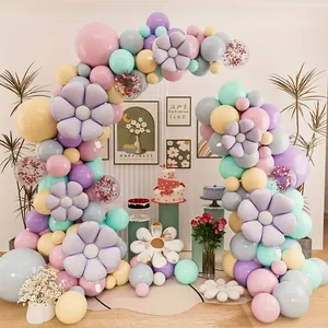 Macro detail of macaron balloon arch with lavender daisies and sequin accents