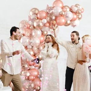 Rose gold and white balloon arch kit with metallic finish and butterfly decorations