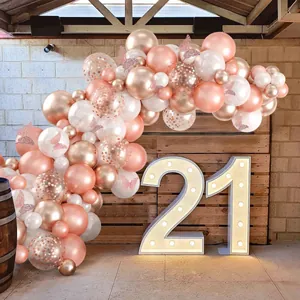 Detail of rose gold balloon arch kit with metallic balloons and butterfly stickers