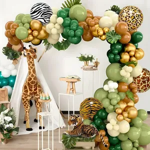 Jungle theme balloon arch with animal prints, gold accents, and decorative palm leaves