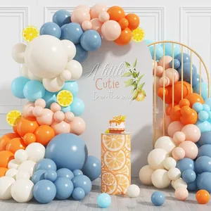 Orange and blue balloon garland arch kit with a Little Cutie backdrop for kids parties