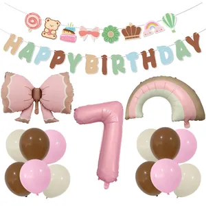 Pink number 7 and bow foil balloons with rainbow and happy birthday banners for kids