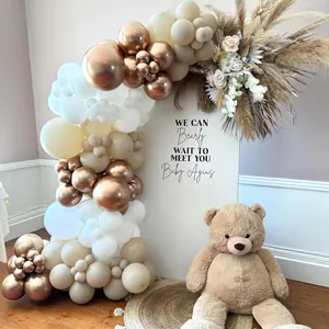 Detail of champagne gold and beige balloon arch with metallic rose gold accents for party