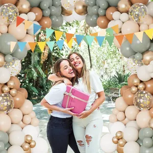 Matte eucalyptus green and gold balloon arch kit with decorative triangle bunting flags