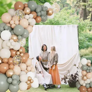 Outdoor wedding balloon arch with sage green, cream, tan and gold metallic balloons
