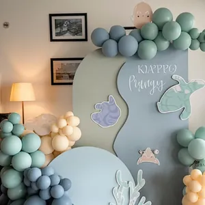 Ocean theme party arch with vintage blue balloons and marine animal paper decorations