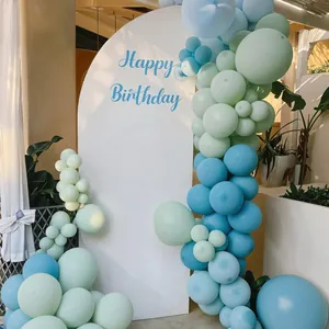 Outdoor birthday setup with blue balloons and a Happy Birthday arch for party decoration
