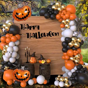Detail of Halloween balloon arch with pumpkin foil balloon and stars for party backdrop