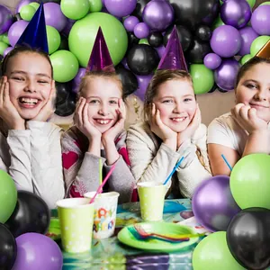 Purple and green balloon arch kit with children for Halloween party decoration