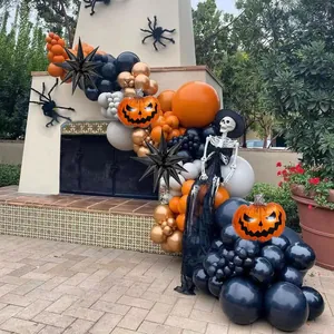 Outdoor Halloween balloon arch with orange, black and copper pumpkins and star balloons