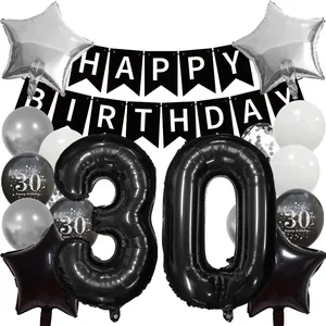 Detail of 30th birthday party set with black and silver balloons and banners