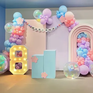 Detail of macaron balloon arch with glowing number 8 and Morandi backdrop for 8th birthday