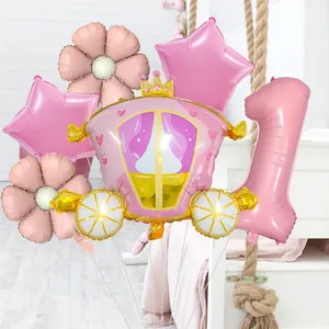 Detail of pink princess carriage and number one foil balloons for first birthday party