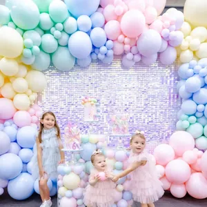 Detail of macaron balloon arch with purple sequin backdrop for 6th birthday party setup