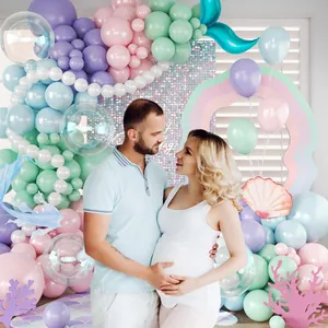 Mermaid theme balloon arch kit with pink and purple latex balloons and foil fishtails